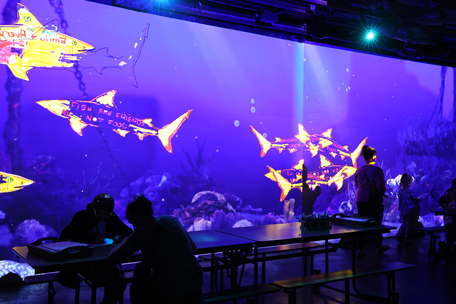 Guests take part in adding their drawings to the Virtual Aquarium experience.