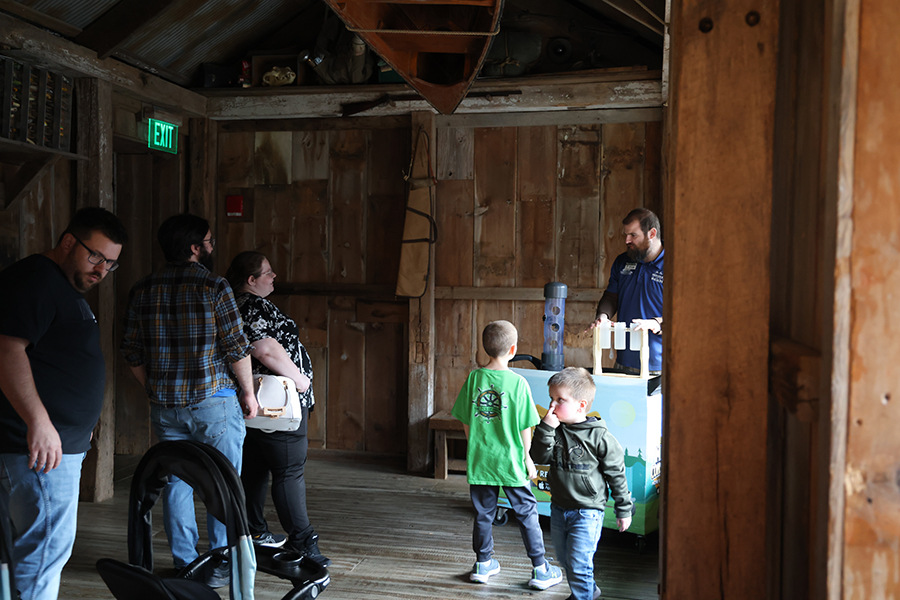 A staff member gives onlooking guests a demonstration.